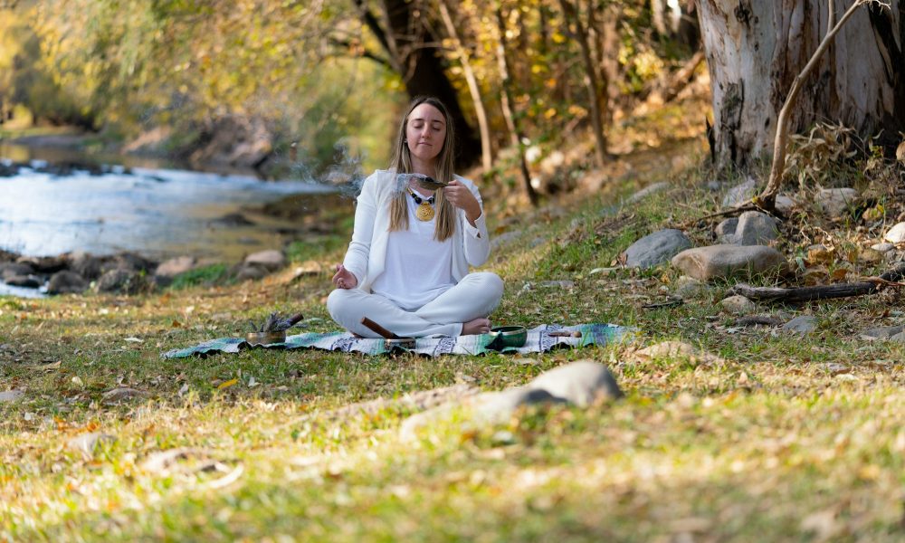 woman doing rituals in the nature for mental health